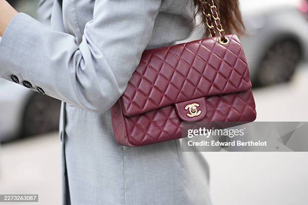 Patricia Gloria Contreras wears a light gray tailored blazer jacket, a burgundy quilted leather shoulder bag with a gold-tone chain strap, during a...