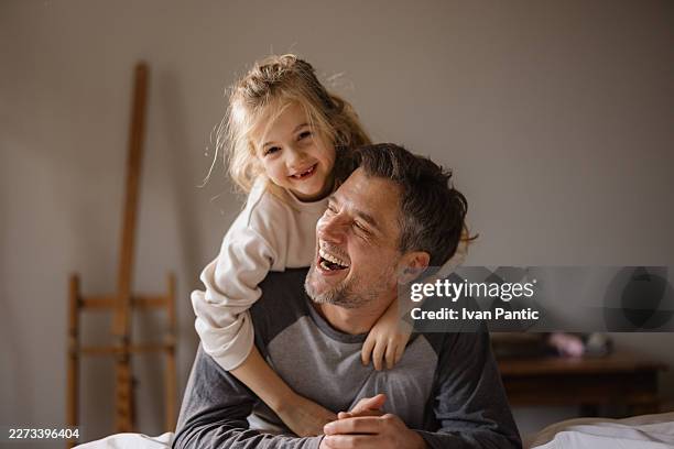 father and daughter having fun together indoors - modern manhood stock pictures, royalty-free photos & images