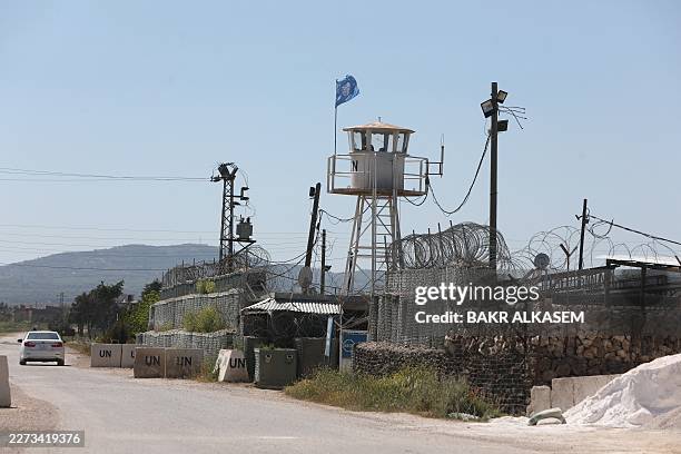 Car drives past an UN Disengagement Observer Force outpost in the southern Syrian village of Khan Arnabah in the province of Quneitra on April 29,...