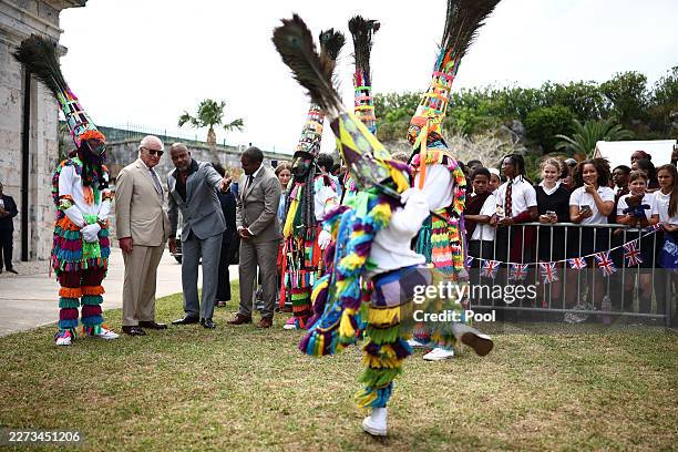 Britain's King Charles III is greeted by Gombey dancers during a cultural welcome at the Royal Naval Dockyard on May 1, 2026 in Sandys Parish,...