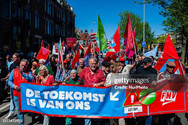 People march in Amsterdam, Netherlands, on May 1 during a demonstration against the cabinet's austerity plans for social security and the war.