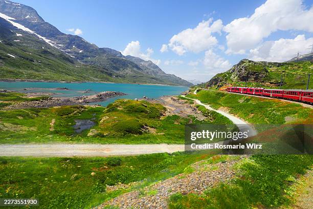 bernina express train in breathtaking landscape - swiss culture stock pictures, royalty-free photos & images