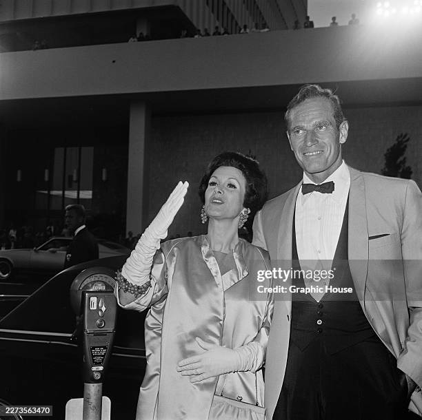 American actress Lydia Clarke and her husband, American actor Charlton Heston, attend the Hollywood premiere of 'Khartoum' at the Cinerama Dome in...
