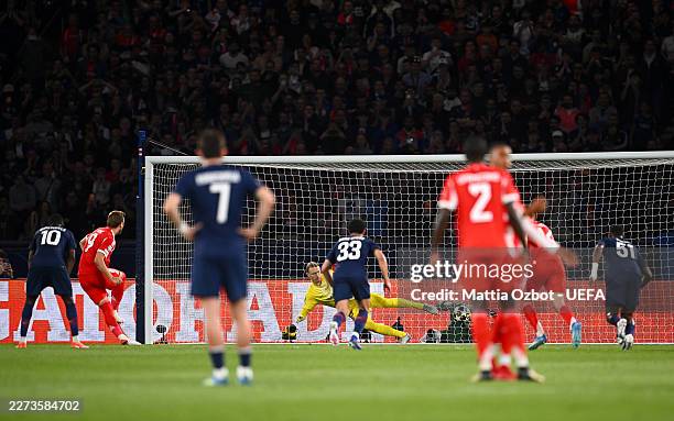 Harry Kane of FC Bayern Munich scores his team's first goal from the penalty-spot past Matvey Safonov of Paris Saint-Germain during the UEFA...