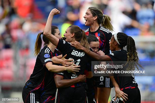 Lyon's German forward Jule Brand celebrates with teammates after scoring a goal during the women's UEFA Champions League second-leg semi-final...