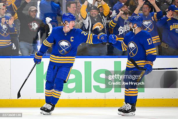 Rasmus Dahlin of the Buffalo Sabres celebrates with Jason Zucker after scoring a goal against Jeremy Swayman of the Boston Bruins during the first...