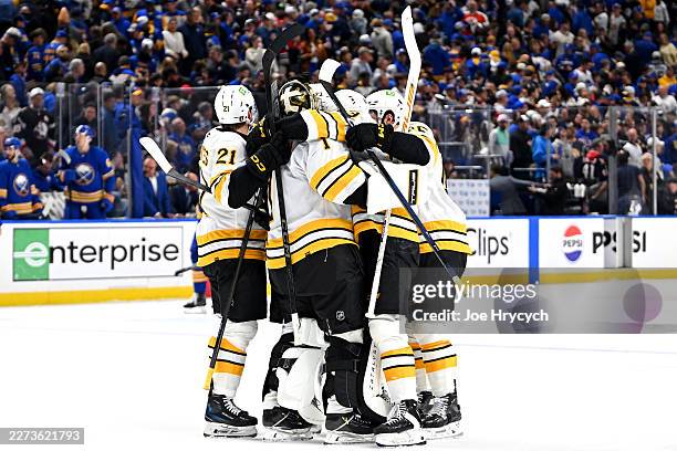Teammates celebrate the goal scored by David Pastrnak of the Boston Bruins against the Buffalo Sabres during overtime in Game Five of the First Round...