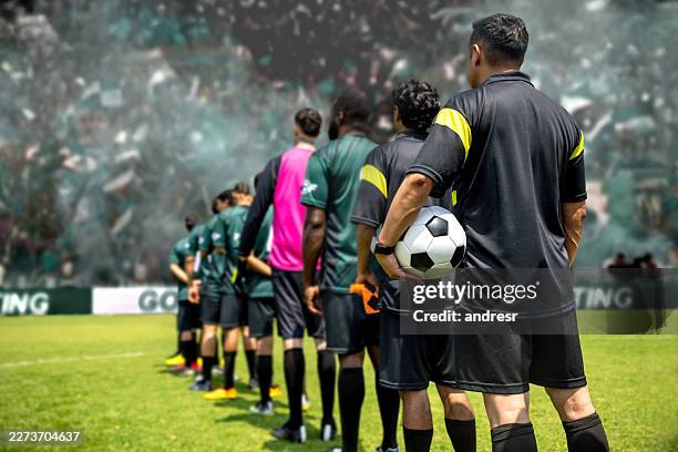 soccer referees lined up with players at a football stadium before a match - sports official stock pictures, royalty-free photos & images