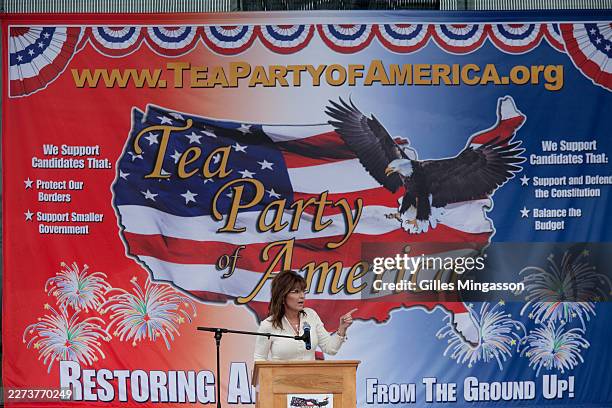 Sarah Palin addresses a Tea Party "Restore America" rally in rural Iowa in front of screen displaying a large American flag, on September 02, 2011 in...