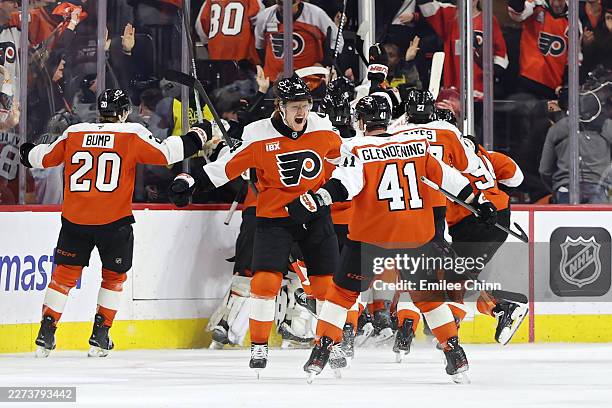 Owen Tippett and Luke Glendening of the Philadelphia Flyers celebrate after defeating the Pittsburgh Penguins 1-o during the first overtime period in...