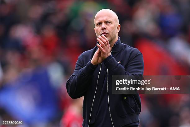 Dejected Arne Slot manager / head coach of Liverpool applauds the fans at full time during the Premier League match between Manchester United and...