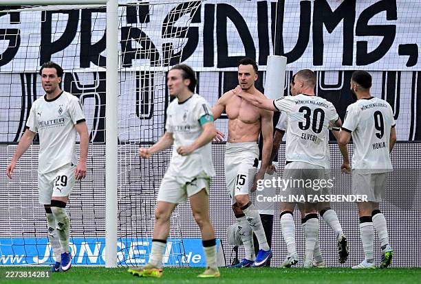 Moenchengladbach's Bosnian-Swiss forward Haris Tabakovic took his shirt off as he celebrates scoring the 1-0 goal with his teammates during the...
