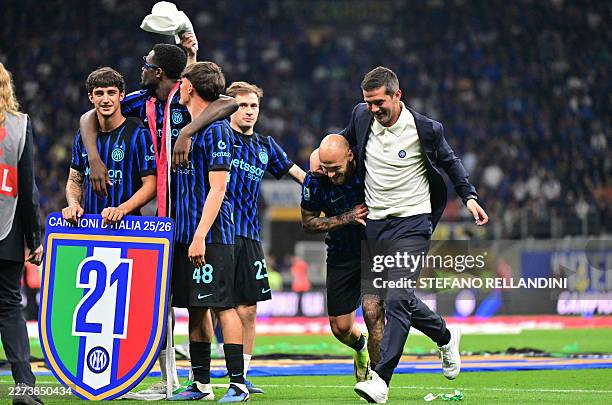 Inter Milan's Romanian head coach Cristian Chivu celebrates with Inter Milan's Italian defender Federico Dimarco after winning the 21st 'scudetto'...