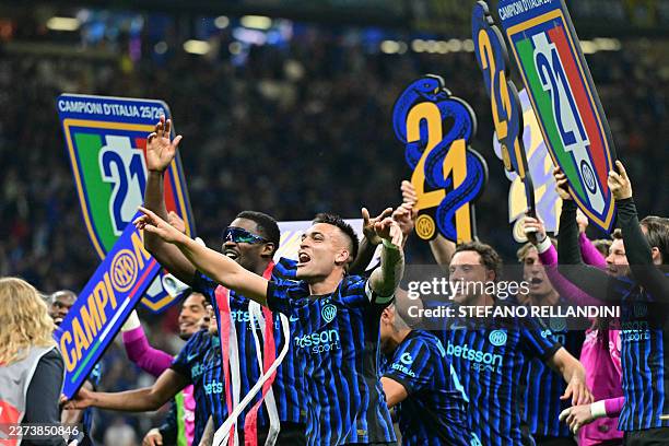 Inter Milan's French forward Marcus Thuram and Inter Milan's Argentinian forward Lautaro Martinez celebrate with teammates after winning the 21st...