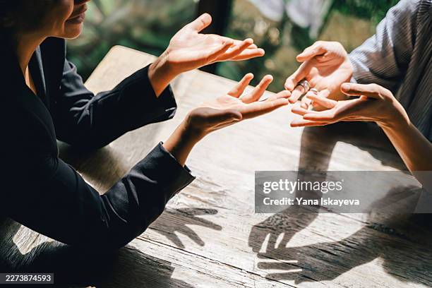 unrecognizable people in the middle of a dynamic brainstorm an argument - relatieproblemen stockfoto's en -beelden