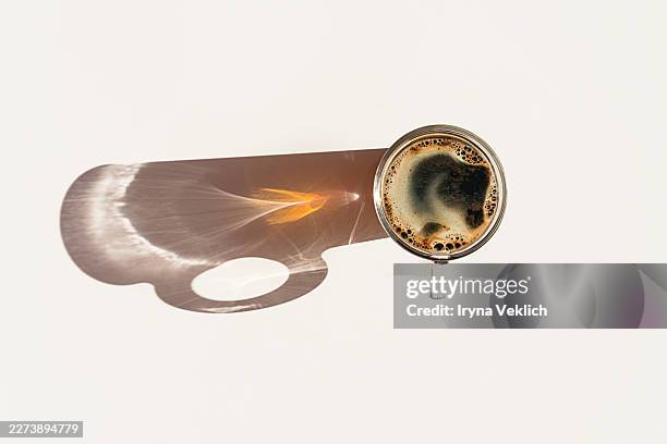 cup of coffee with creative shadow top view minimal composition. - coffee roast stock pictures, royalty-free photos & images