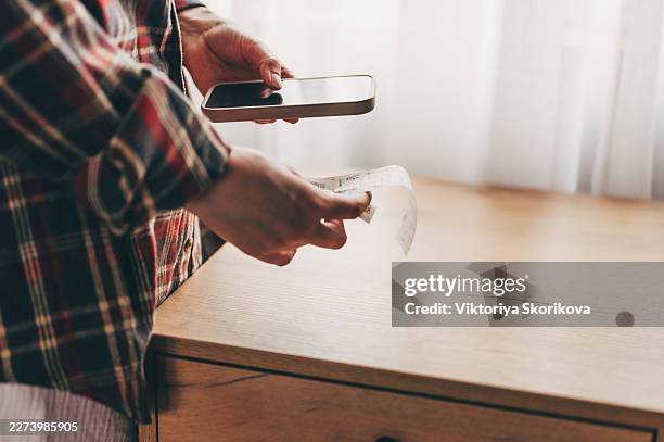 bill pay concept. online internet banking woman hand holding receipt paper, using mobile smart phone with calculator apps for calculate expenses to pay of monthly. technology of financial. - receipt stock pictures, royalty-free photos & images
