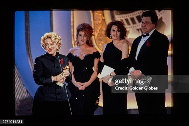 Bette Midler with Joely Fisher, Kate Nelligan and John Goodman at the 49th Annual Golden Globe Awards at the Beverly Hilton Hotel on January 18, 1992...