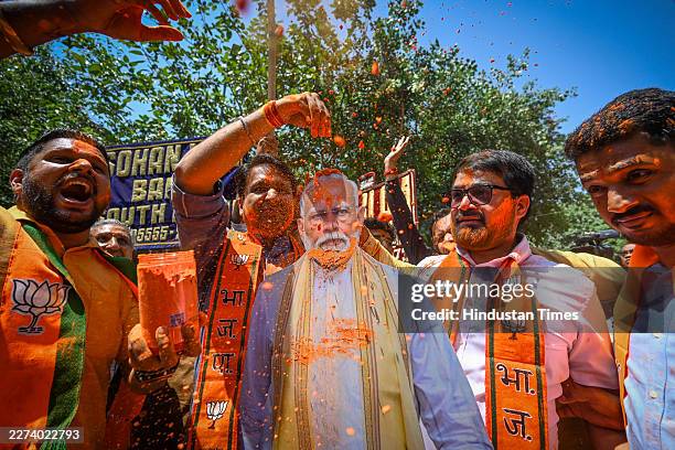Supporters celebrate after trends show party's victory in West Bengal, Assam and Puduchery State Assembly elections outside BJP Headquarters on May...