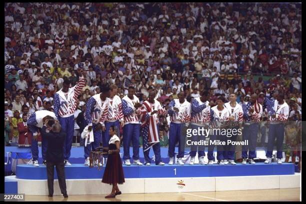 Christian Laettner of the USA Dream Team bends over to receive his gold medal during the medal ceremony following the basketball finals in the 1992...