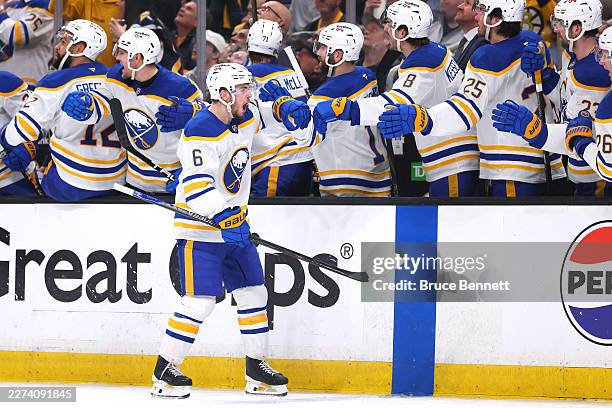 Zach Benson of the Buffalo Sabres is congratulated by his teammates after scoring a goal against the Boston Bruins during the third period in Game...