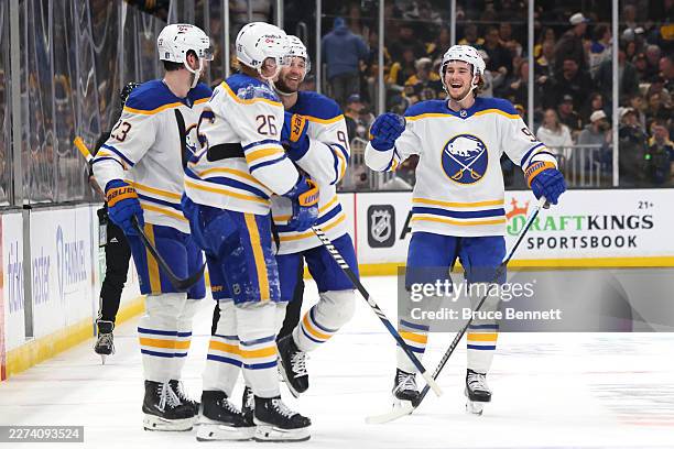 Josh Norris of the Buffalo Sabres is congratulated by his teammates after scoring an empty-net goal against the Boston Bruins during the third period...