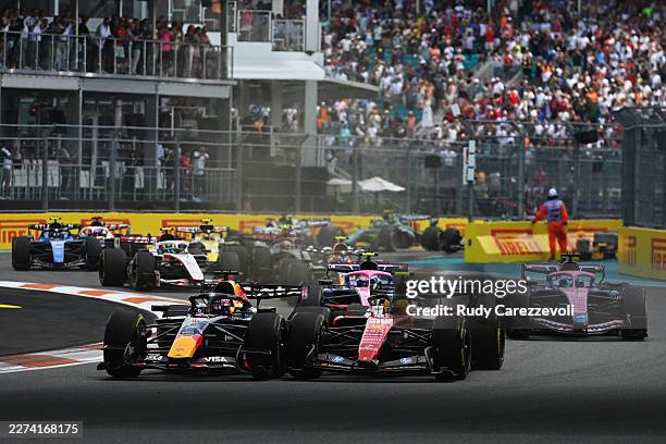 Max Verstappen of the Netherlands driving the Oracle Red Bull Racing RB22 Red Bull Ford and Lewis Hamilton of Great Britain driving the Scuderia...