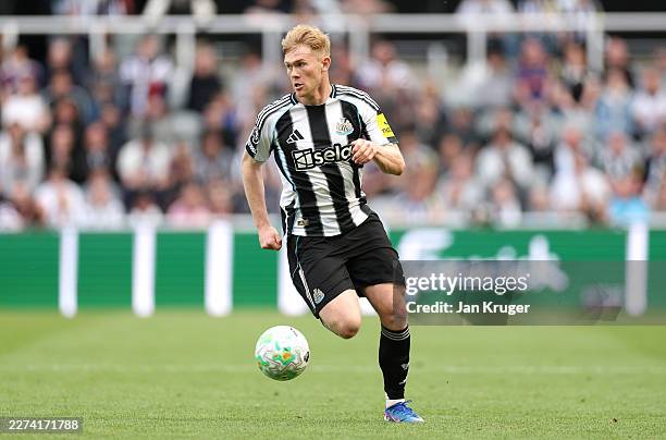 Lewis Hall of Newcastle United controls the ball during the Premier League match between Newcastle United and Brighton & Hove Albion at St James'...