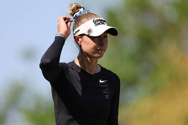Nelly Korda of the United States puts a tee in her hair after playing her shot from the ninth tee during the third round of the Mexico Riviera Maya...