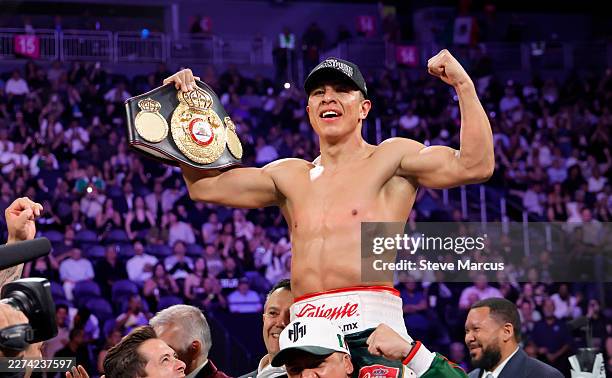 Jaime Munguia celebrates with the title belt after defeating WBA super middleweight champion Armando Resendiz in a title fight at T-Mobile Arena on...