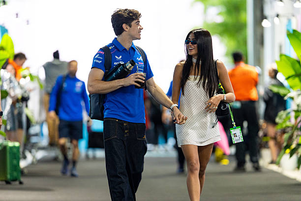 Franco Colapinto of Argentina and Alpine F1 Team walks in the paddock with Maia Reficco during the F1 Grand Prix of Miami at Miami International...