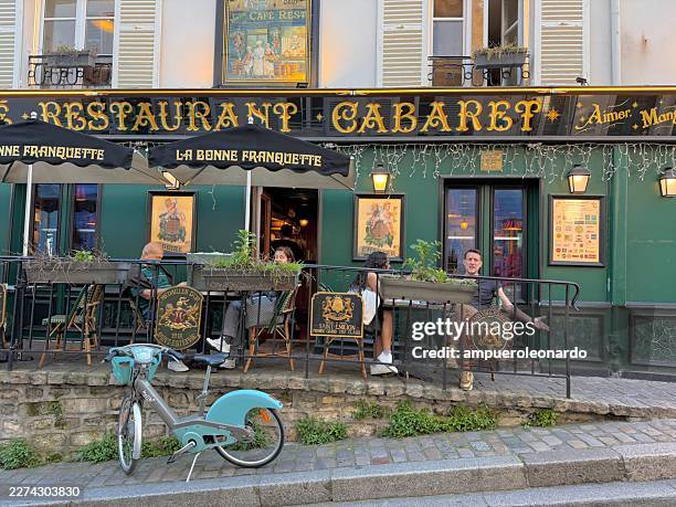 people relaxing in la bonne franquette cafe montmartre paris france - charming stock pictures, royalty-free photos & images