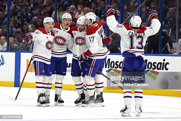 Nick Suzuki of the Montreal Canadiens celebrates with his teammates after scoring a goal on Andrei Vasilevskiy of the Tampa Bay Lightning during the...