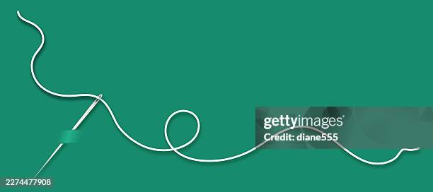 needle and thread sewing on a green background with copy space - embroidery thread stock illustrations