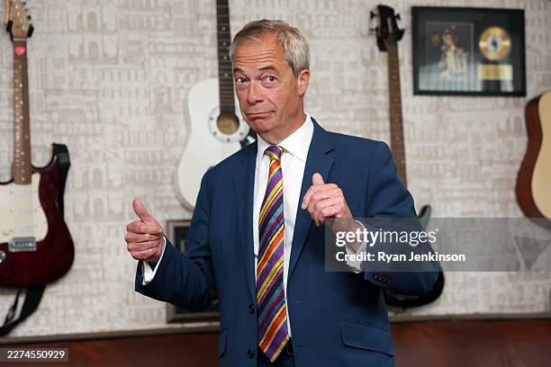 Reform UK leader Nigel Farage gives a thumbs up to the media at The Dam Bar And Grill on May 08, 2026 in St Helens, England. Voters went to the polls...