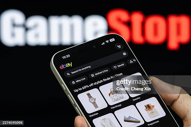 In this photo illustration, a smartphone displays the eBay app, with GameStop branding visible in the background, on May 5 in Shenzhen, Guangdong...