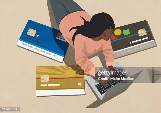 high angle view large credit cards surrounding young woman using laptop - excess stock illustrations