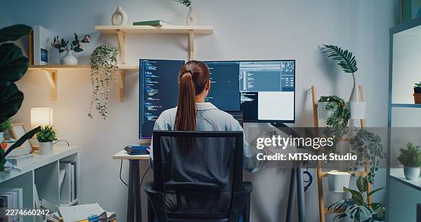 young asian female computer programmer works on software development using multiple screens in home office. telecommuting, digital transformation, expertise coding, artificial intelligence concept. - programmer working stock pictures, royalty-free photos & images