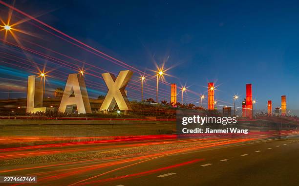 lax sign with red light trails and illuminated pylons at night, los angeles california usa - lax airport stock pictures, royalty-free photos & images