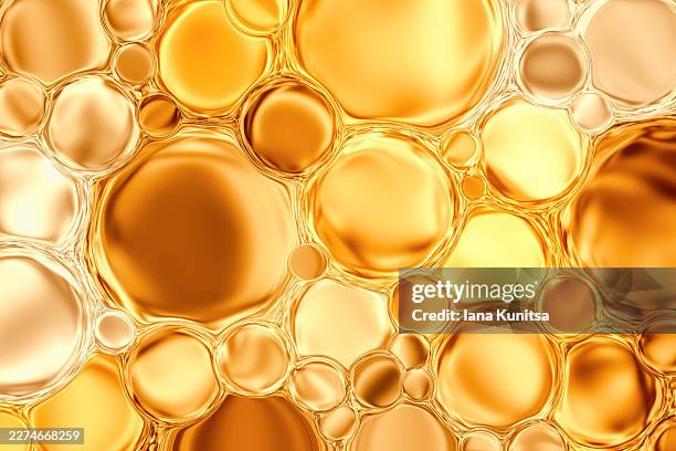 abstract metallic golden yellow liquid bubbles for skincare serum, biotechnology and microscopic biology. futuristic cells, molecules and cosmetic texture symbolizing hydration, anti aging, scientific research and luxury beauty care concepts. - facial oil stock pictures, royalty-free photos & images