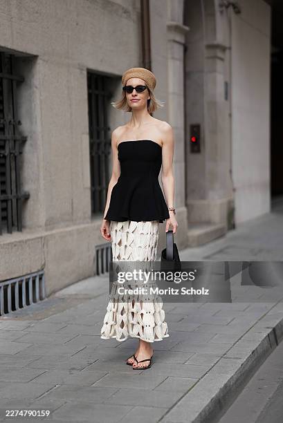 Marlies Pia Pfeifhofer is seen wearing a black strapless peplum tube top from H&M; a cream open-knit crochet midi skirt in a flared silhouette from...
