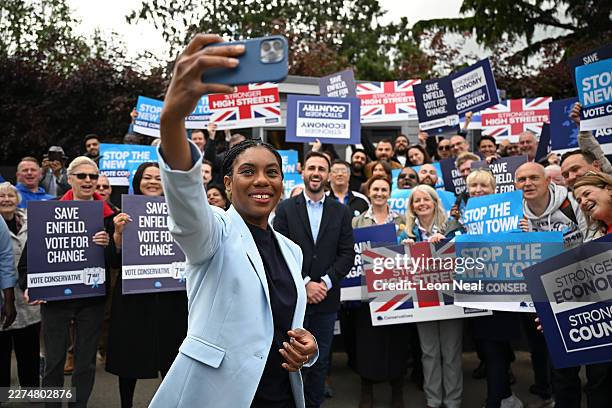 Conservative Party Leader Kemi Badenoch takes a selfie with supporters during a visit to Thompsons of Crews Hill garden centre in Enfield as they...