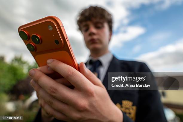 In this photo illustration a 15-year-old teenage boy looks at an iPhone smartphone screen on May 6, 2026 in Bath, England. In the UK, a ban on social...