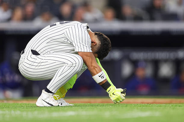 José Caballero of the New York Yankees reacts to being hit by a pitch during the third inning against the Texas Rangers at Yankee Stadium on May 06,...