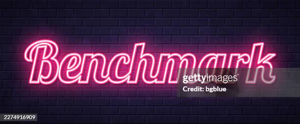 benchmark - glowing neon text on brick wall background - yard stick stock illustrations