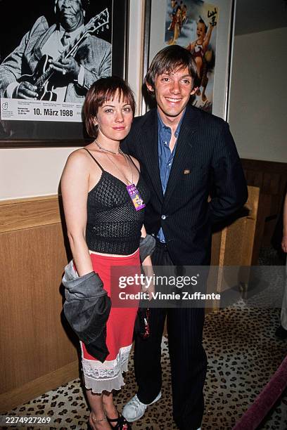 American actress Natasha Gregson Wagner, wearing a black top with a red-and-white skirt, and American actor Lukas Haas, who wears a black pinstripe...