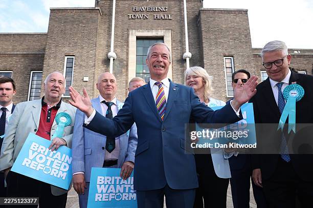 Reform UK leader Nigel Farage poses with winning councillors outside Havering Town Hall following the 2026 local election results on May 08, 2026 in...