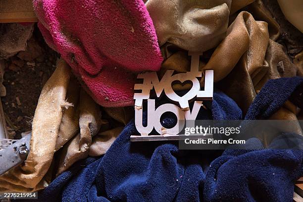 Belongings of wounded residents lie scattered inside an apartment damaged in the aftermath of a Russian Shahed drone strike on May 12, 2026 in...