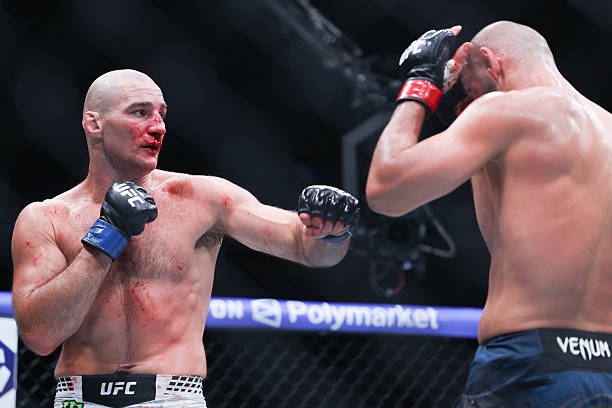 Sean Strickland of the United States fights Khamzat Chimaev of the United Arab Emirates in a middleweight title bout during UFC 328 at the Prudential...