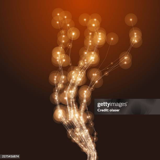 glowing golden light trails rise through a dark brown background, forming a vertical stream of sparkling points and soft circular bokeh highlights. - warm light background stock illustrations